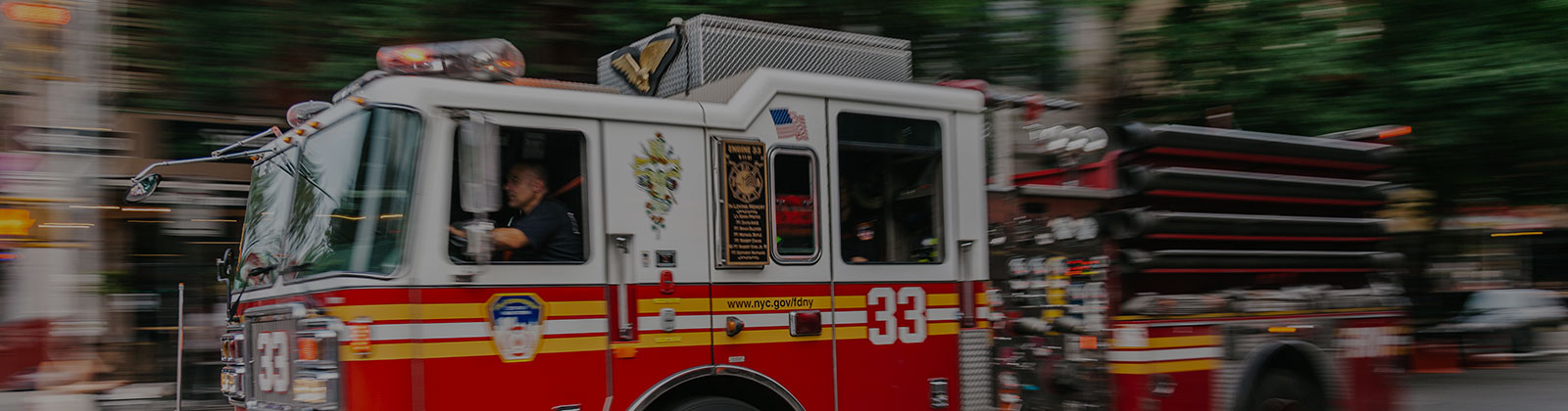 firetruck driving on a city street