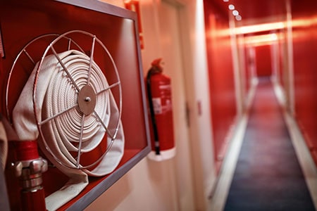 fire hose and fire extinguisher on a wall